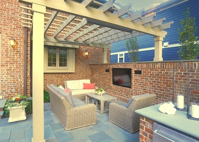 Mid-sized transitional backyard stone patio kitchen photo with a pergola
